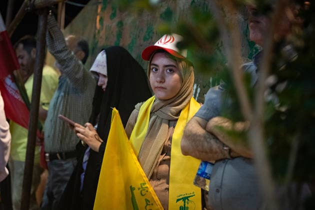 An Iranian girl carries of Hezbollah, the Lebanese group, is a key ally of Iran flag during a rally , as crowds wave flags in support of the government s negotiations to end the war with the United States. Anti?U.S. and anti?Israel chants echoed through Enghelab Square in Tehran late Friday, June 12, 2026.  IRN2026061219 BehnamxTofighi