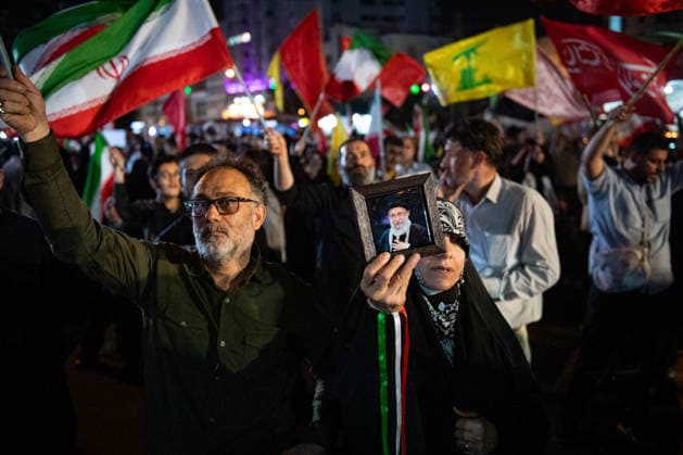 Iranians wave their National flag during a rally in support of the government s negotiations to end the war with the United States at Enghelab Square in Tehran, Iran on Friday, June 12, 2026.  IRN2026061225 BehnamxTofighi