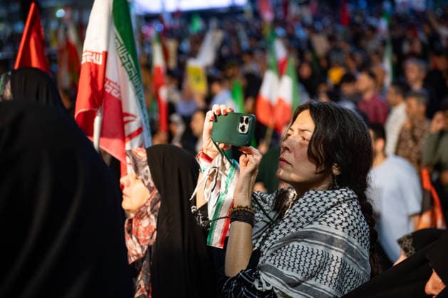 An Iranian woman wearing a keffiyeh attends a rally in support of the Iranian government s negotiations to end the war with the United States at Enghelab Square in Tehran, Iran on Friday, June 12, 2026.  IRN2026061228 BehnamxTofighi