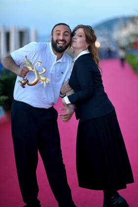40th Cabourg Film Festival Day 3 FC Oussama Kheddam and Agnes Jaoui pose with his award on the red carpet during Day Three of the 40th Cabourg Film Festival on June 12, 2026 in Cabourg, France.. Photo by Franck Castel ABACAPRESS.COM Cabourg  Copyright: xCastelxFranck ABACAx