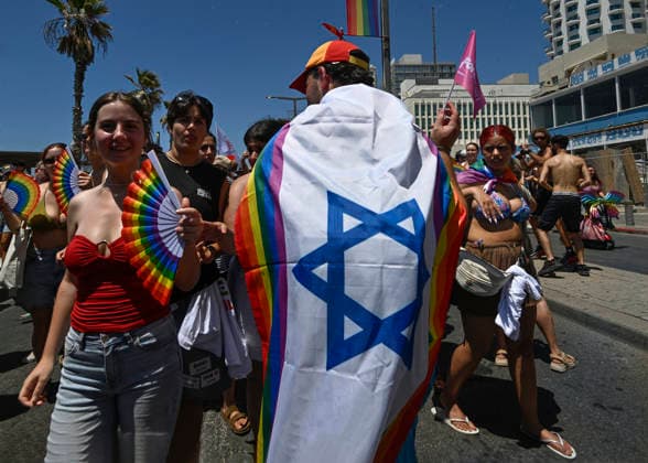 June 12, 2026, Tel Aviv, Israel: A protester carries a flag that is half Israeli flag and half Pride flag during the Pride parade. The Pride Parade in Tel Aviv, Israel, took place after a three-year hiatus due to the war. This year as well, the war remained a backdrop to the event, as Tel Aviv had been targeted by Iranian missile attacks just a few days earlier. Despite these challenges, thousands of people across Israel came out to celebrate love, pride, and equality, marching in support of equal rights for the LGBTQ+ community, including gay men and lesbians. Tel Aviv Israel - ZUMAs197 20260612_aaa_s197_452 Copyright: xYaelxGuiskyxAbasx