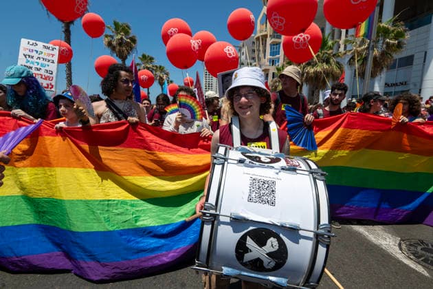 June 12, 2026, Tel Aviv, Israel: Young people march in the Pride Parade carrying a large Pride flag in support of LGBTQ+ rights. The Pride Parade in Tel Aviv, Israel, took place after a three-year hiatus due to the war. This year as well, the war remained a backdrop to the event, as Tel Aviv had been targeted by Iranian missile attacks just a few days earlier. Despite these challenges, thousands of people across Israel came out to celebrate love, pride, and equality, marching in support of equal rights for the LGBTQ+ community, including gay men and lesbians. Tel Aviv Israel - ZUMAs197 20260612_aaa_s197_463 Copyright: xYaelxGuiskyxAbasx