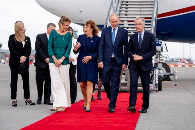 June 13, 2026, Dublin, Ireland: Prime Minister Mark Carney walks with the Taoiseach of Ireland Micheal Martin while Diana Fox Carney speaks with spouse of the Taoiseach, Mary Martin, as they arrive in Dublin, Ireland, on Saturday, June 13, 2026. Dublin Ireland  - ZUMAc35_ 20260613_zaf_c35_006 Copyright: xChristopherxKatsarovx