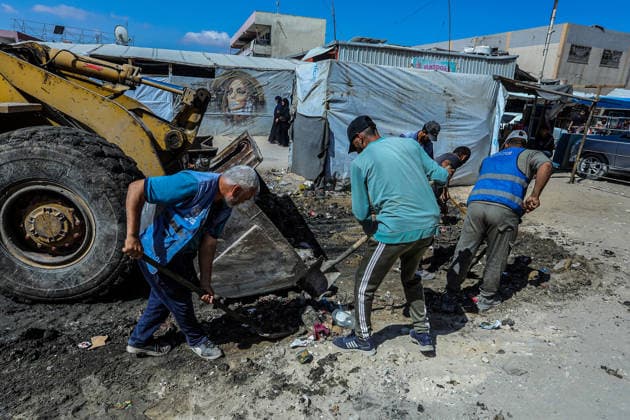Teams affiliated with UNRWA carry out cleaning operations in Khan Yunis KHAN YUNIS, GAZA, PALESTINE - JUNE 13: Teams from the United Nations Relief and Works Agency for Palestine Refugees in the Near East (UNRWA) use heavy machinery to remove garbage piled up on the streets of Khan Yunis, Gaza, Palestine, on June 13, 2026. Waste has been accumulating on streets and near residential areas due to severe damage to infrastructure caused by attacks, insufficient municipal vehicles. Abed Rahim Khatib Anadolu Khan Yunis Gaza. Editorial use only. Please get in touch for any other usage.  Copyright: x2026xAnadoluxAbedxRahimxKhatibx