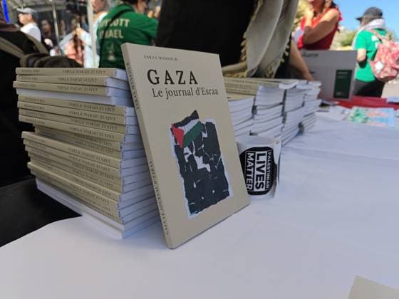 Rally in support of Palestinians organized by EuroPalestine in Paris PARIS, FRANCE - JUNE 13: A book is seen on the stand as demonstrators wave Palestinian flags during a rally organized by EuroPalestine at the Fontaine des Innocents in Paris, France, on June 13, 2026. Awareness and document distribution stands were set up on site as participants denounced the war in Gaza and reaffirmed their support for the Palestinian people. Umit Donmez Anadolu Paris France. Editorial use only. Please get in touch for any other usage.  Copyright: x2026xAnadoluxUmitxDonmezx