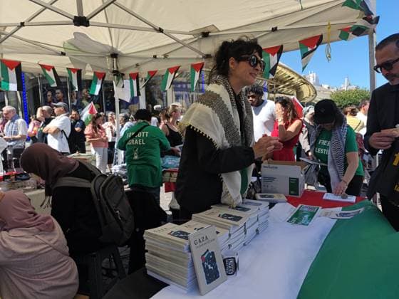 Rally in support of Palestinians organized by EuroPalestine in Paris PARIS, FRANCE - JUNE 13: A book stand is seen as demonstrators wave Palestinian flags during a rally organized by EuroPalestine at the Fontaine des Innocents in Paris, France, on June 13, 2026. Awareness and document distribution stands were set up on site as participants denounced the war in Gaza and reaffirmed their support for the Palestinian people. Umit Donmez Anadolu Paris France. Editorial use only. Please get in touch for any other usage.  Copyright: x2026xAnadoluxUmitxDonmezx