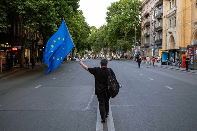 June 13, 2026, Tbilisi, Georgia: A woman waves the European Union flag while she and other protesters participate on the 563rd day of anti-government rallies in Tbilisi. Tbilisi Georgia - ZUMAz174 20260613_zip_z174_001 Copyright: xMoexZoyarix
