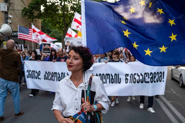 June 13, 2026, Tbilisi, Georgia: A woman holds the European Union flag while she and other protesters participate on the 563rd day of anti-government rallies in Tbilisi. Tbilisi Georgia - ZUMAz174 20260613_zip_z174_002 Copyright: xMoexZoyarix