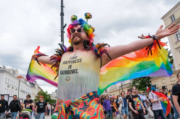 June 13, 2026, Warsaw, Masovian Voivodeship, Poland: A person wearing a rainbow outfit proudly displays a shirt that reads I find happiness in rainbows during the 25th annual Warsaw LGBTQ+ Pride Parade, known in Polish as the Equality Parade. LGBTQ+ people in Poland do not have the right to same-sex civil partnerships, marriage, and child adoption, while also facing homophobia and queerphobia from a largely conservative society. Therefore, the parade is organized primarily as a march for equal rights. Warsaw Poland - ZUMAk204 20260613_zip_k204_015 Copyright: xRomanxKozielx