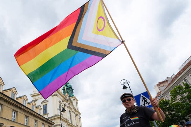 June 13, 2026, Warsaw, Masovian Voivodeship, Poland: A person waves a large rainbow pride flag during the 25th annual Warsaw LGBTQ+ Pride Parade, known in Polish as the Equality Parade. LGBTQ+ people in Poland do not have the right to same-sex civil partnerships, marriage, and child adoption, while also facing homophobia and queerphobia from a largely conservative society. Therefore, the parade is organized primarily as a march for equal rights. Warsaw Poland - ZUMAk204 20260613_zip_k204_013 Copyright: xRomanxKozielx