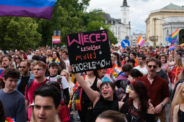 June 13, 2026, Warsaw, Masovian Voivodeship, Poland: A person holds up a sign that reads more lesbians, less problems as thousands of people march during the 25th annual Warsaw LGBTQ+ Pride Parade, known in Polish as the Equality Parade. LGBTQ+ people in Poland do not have the right to same-sex civil partnerships, marriage, and child adoption, while also facing homophobia and queerphobia from a largely conservative society. Therefore, the parade is organized primarily as a march for equal rights. Warsaw Poland - ZUMAk204 20260613_zip_k204_023 Copyright: xRomanxKozielx