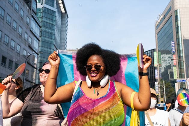 June 13, 2026, Seoul, South Korea: A participant wearing pride flags colored clothes holds a pride flag during the Seoul Queer Parade in Seoul downtown. The 27th Seoul Queer Parade (SQP) was held in Seoul, South Korea..It is a public cultural event held downtown every year to promote LGBTQIA+ visibility, human rights, cultural enjoyment, and pride. Seoul South Korea - ZUMAs197 20260613_aaa_s197_185 Copyright: xSimonxShinx