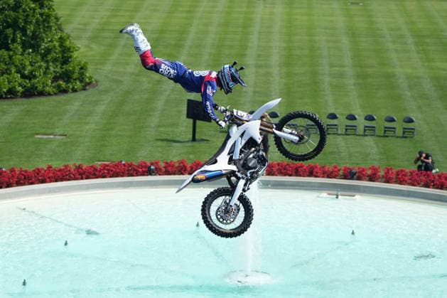 A motor sports athlete and stunt performer does a motorcycle jump ahead of the UFC Freedom 250 fights on the South Lawn of the White House in Washington, DC on Saturday, June 13, 2026.  WASP20260613106 MarkxSchiefelbein