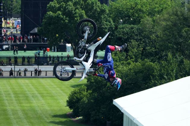 A motor sports athlete and stunt performer does a motorcycle jump ahead of the UFC Freedom 250 fights on the South Lawn of the White House in Washington, DC on Saturday, June 13, 2026.  WASP20260613113 MarkxSchiefelbein