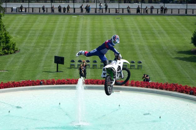 A motor sports athlete and stunt performer does a motorcycle jump ahead of the UFC Freedom 250 fights on the South Lawn of the White House in Washington, DC on Saturday, June 13, 2026.  WASP20260613114 MarkxSchiefelbein