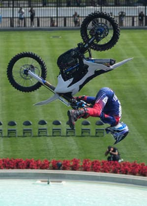 A motor sports athlete and stunt performer does a motorcycle jump ahead of the UFC Freedom 250 fights on the South Lawn of the White House in Washington, DC on Saturday, June 13, 2026.  WASP20260613116 MarkxSchiefelbein