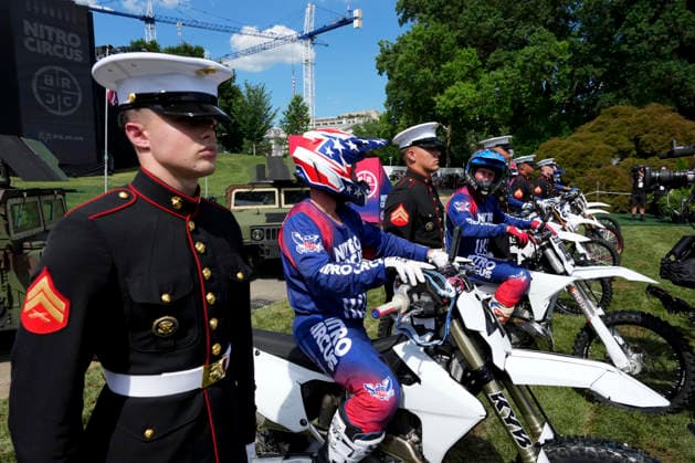 Motorsports athletes and stunt performers line up alongside members of the military after doing a motorcycle jump ahead of the UFC Freedom 250 fights on the South Lawn of the White House in Washington, DC Saturday, June 13, 2026.  WASP20260613117 AlexxBrandon