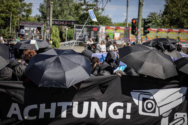 June 13, 2026, Berlin, Berlin, Germany: Demonstrators march through the streets of Berlin, Germany, protesting against the expansion of police surveillance technologies, biometric monitoring systems, facial recognition tools, and the use of artificial intelligence in law enforcement on June 13, 2026. Participants carried banners, flags, umbrellas, and symbolic props, including representations of surveillance cameras, while voicing concerns over privacy rights, state monitoring, and civil liberties. The demonstration was monitored by Berlin police as protesters gathered at several locations across the city demanding greater protections against digital surveillance and data collection. Berlin Germany  - ZUMAa268 20260613_zip_a268_009 Copyright: xAbdelrahmanxAlkahloutx