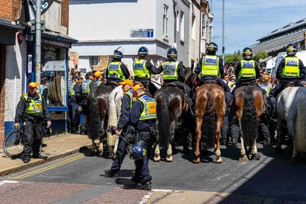 June 13, 2026, Brighton, UK: Brighton, UK. 13 June 2026. Police officers during an anti-immigration protest in the city centre of Brighton. The South East Patriots group hold a march through the centre of Brighton, with about twenty groups under the banner the Carnival Against Fascism organising a counter protest. Police officers kept the two groups apart as tensions were running high. South East Patriots claimed the protest was to demand stronger border control, enforcement of immigration laws, and the deportation of illegal immigrants, with the counter protest groups expressing their resistance against the far right as well as to any form of fascism and racism Brighton UK - ZUMAd99_ 20260613_zap_d99_068 Copyright: xMattxDuckettx