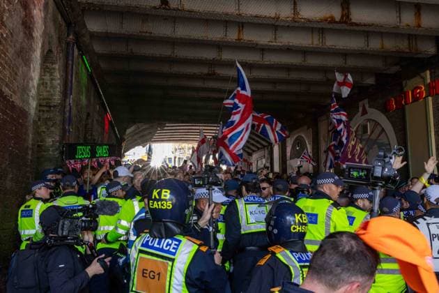 June 13, 2026, Brighton, UK: Brighton, UK. 13 June 2026. Police officers during an anti-immigration protest in the city centre of Brighton. The South East Patriots group hold a march through the centre of Brighton, with about twenty groups under the banner the Carnival Against Fascism organising a counter protest. Police officers kept the two groups apart as tensions were running high. South East Patriots claimed the protest was to demand stronger border control, enforcement of immigration laws, and the deportation of illegal immigrants, with the counter protest groups expressing their resistance against the far right as well as to any form of fascism and racism Brighton UK - ZUMAd99_ 20260613_zap_d99_124 Copyright: xMattxDuckettx