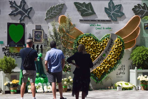 June 14, 2026, London, England, United Kingdom: People gather at the memorial wall next to Grenfell Tower on the ninth anniversary of the disaster. 72 people died when a fire broke out in the block of flats in North Kensington in 2017. London United Kingdom - ZUMAv130 20260614_zip_v130_002 Copyright: xVukxValcicx