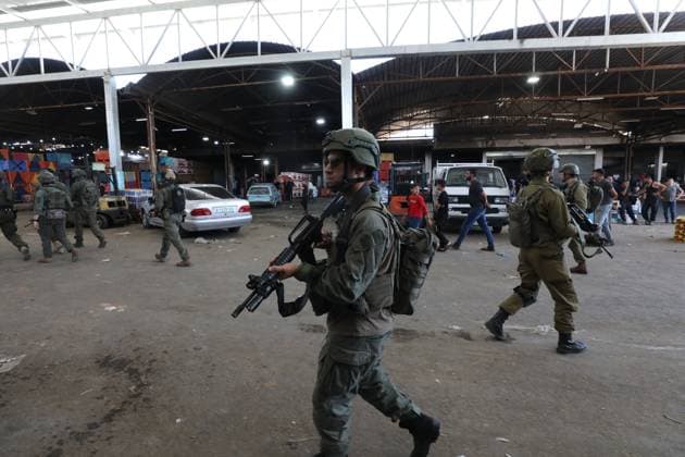 Israeli Forces Conduct Raid in Central Market Area of Nablus NABLUS, WEST BANK JUNE 14, 2026: Israeli soldiers are seen in the central vegetable market area during a military raid in the city of Nablus, in the occupied West Bank. NABLUS Palestine, State of Copyright: x xJNAxEDITORx xJNAxPressx