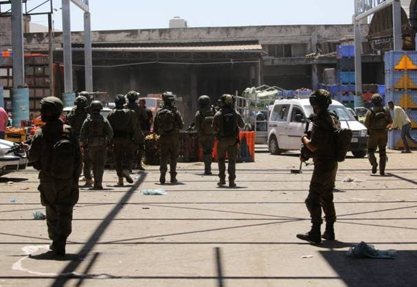 Israeli Forces Conduct Raid in Central Market Area of Nablus NABLUS, WEST BANK JUNE 14, 2026: Israeli soldiers are seen in the central vegetable market area during a military raid in the city of Nablus, in the occupied West Bank. NABLUS Palestine, State of Copyright: x xJNAxEDITORx xJNAxPressx