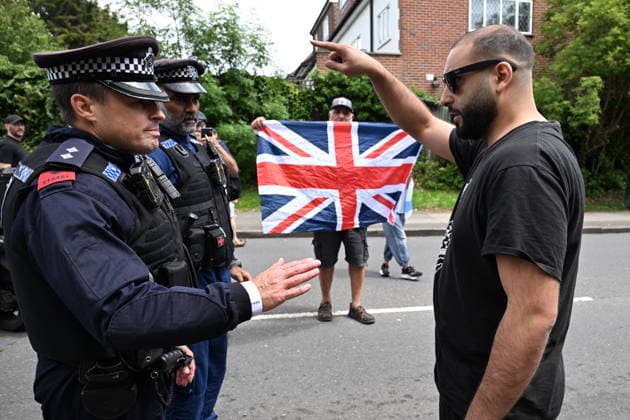 June 14, 2026, London, London, UK: London, UK. A Pro Palestinian protester is turned away by police officers as Pro Israeli protesters hold demonstrations near the Edgware United Synagogue who are hosting a Great Israeli Real Estate event. The organisers are allegedly offering to sell stolen Palestinian land including in settlements in the occupied territories. London UK  - ZUMAl94_ 20260614_zaf_l94_028 Copyright: xRayxTangx