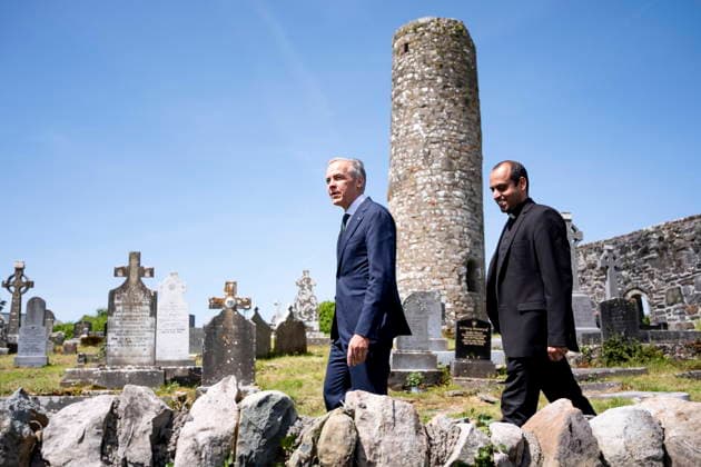 June 14, 2026, Aghagower, County Mayo, Ireland: Prime Minister Mark Carney walks in the St Patrick Church cemetary with Father Britus Kadavunkal Francis, in Aghagower, County Mayo, Ireland, on Sunday, June 14, 2026. Aghagower, County Mayo Ireland  - ZUMAc35_ 20260614_zaf_c35_032 Copyright: xChristopherxKatsarovx