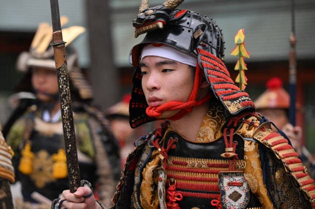 Osaka Keeps Centuries Old Otaue Rice Festival alive OSAKA, JAPAN - JUNE 14: A close-up portrait of a young performer dressed as a Furyu-musha samurai warrior wearing intricate traditional armor (yoroi) and a black lacquered helmet (kabuto) during the historic Otaue Rice Planting Festival (Otaue Shinji) at Sumiyoshi Taisha Shrine in southern Osaka, Japan, on June 14, 2026. The ancient agricultural ritual, officially designated as an Important Intangible Folk Cultural Property of Japan, heavily relies on local youth and preservation societies to maintain the meticulous costuming and historic accuracy of its centuries-old military pageantry. Artur Widak Anadolu Agency Anadolu Osaka Japan. Editorial use only. Please get in touch for any oth  Copyright: x2026xAnadoluxArturxWidak AnadoluxAgencyx