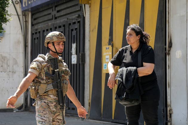 June 14, 2026, Beirut, Beirut, Lebanon: A Lebanese army soldier prevents a resident from passing as he secures the site where a building was targeted by Israeli strike in Beirut southern suburb, a bastion of pro-Iranian Hezbollah. Three people were killed in the attack, according to Lebanon s state media. The Israel Defense Forces (IDF) said it targeted a command center used by Hezbollah after the Iran-backed armed group launched aerial targets toward Israel Beirut Lebanon  - ZUMAn313 20260614_zip_n313_017 Copyright: xMarwanxNaamanix