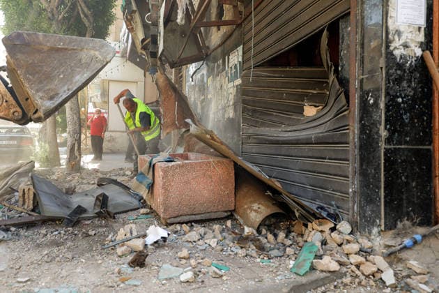 June 14, 2026, Beirut, Beirut, Lebanon: A municipality worker clears rubble in the premises of a building that was targeted by Israeli strike in Beirut southern suburb, a bastion of pro-Iranian Hezbollah. Three people were killed in the attack, according to Lebanon s state media. The Israel Defense Forces (IDF) said it targeted a command center used by Hezbollah after the Iran-backed armed group launched aerial targets toward Israel Beirut Lebanon  - ZUMAn313 20260614_zip_n313_014 Copyright: xMarwanxNaamanix