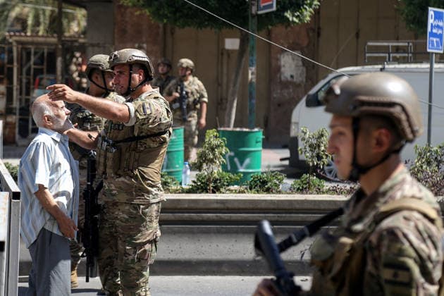 June 14, 2026, Beirut, Beirut, Lebanon: A Lebanese army soldier, securing the site where a building was targeted by Israeli strike in Beirut southern suburb, a bastion of pro-Iranian Hezbollah, prevents a resident from passing to his home. Three people were killed in the attack, according to Lebanon s state media. The Israel Defense Forces (IDF) said it targeted a command center used by Hezbollah after the Iran-backed armed group launched aerial targets toward Israel Beirut Lebanon  - ZUMAn313 20260614_zip_n313_010 Copyright: xMarwanxNaamanix