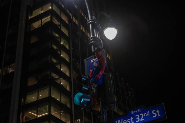 June 14, 2026, New York, United States: A Knicks fan dressed as Spiderman climbs a traffic light during the celebration after the New York Knicks defeated the San Antonio Spurs in Game 5 of the NBA Finals to win the series. The Knicks won the NBA Championship for the first time since 1973, for the third time in franchise history. New York United States - ZUMAs197 20260614_aaa_s197_081 Copyright: xRonxAdarx