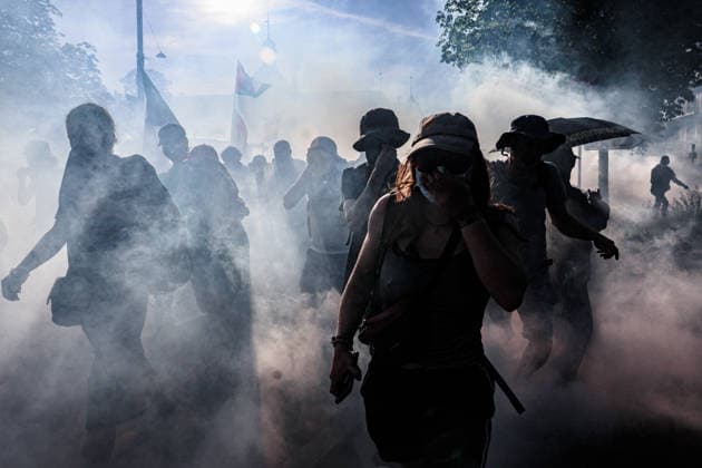 June 14, 2026, Geneva, Switzerland, European Union: Silhouetted protesters run through tear gas fired by police during a demonstration in Geneva ahead of the G7 summit. Geneva European Union  - ZUMAo116 20260614_znp_o116_002 Copyright: xBiancaxOterox
