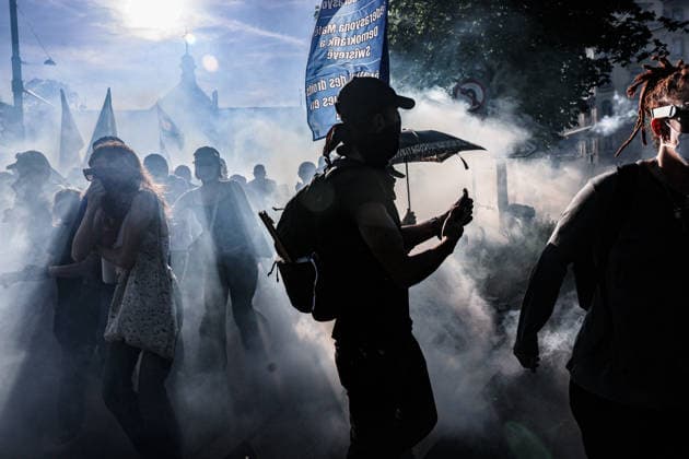 June 14, 2026, Geneva, Switzerland, European Union: Silhouetted protesters run through tear gas fired by police during a demonstration in Geneva ahead of the G7 summit. Geneva European Union  - ZUMAo116 20260614_znp_o116_003 Copyright: xBiancaxOterox