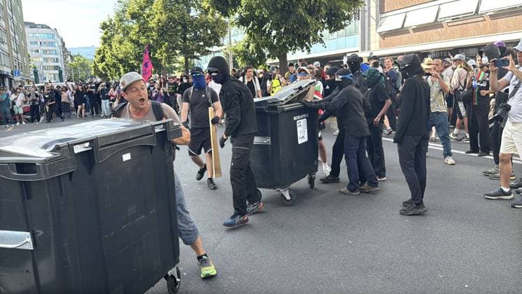 Anti-G7 Protest in Geneva GENEVA, SWITZERLAND - JUNE 14: Demonstrators use large plastic dumpsters as makeshift barricades while marching through the streets during a protest against the G7 Summit in Geneva, Switzerland on June 14, 2026. Tens of thousands of people gathered at Mon Repos Park to protest the upcoming G7 Summit in France, marching through the city center and along Lake Geneva. Many participants carried Palestinian flags, chanting slogans against the G7 and expressing support for Palestine in response to the intense Israeli attacks and blockade in Gaza. What began as a peaceful demonstration ended with police using tear gas to disperse the crowd near Mon Repos Park. Muhammet Ikbal Arslan Anadolu Geneva Switzerland. Editorial  Copyright: x2026xAnadoluxMuhammetxIkbalxArslanx