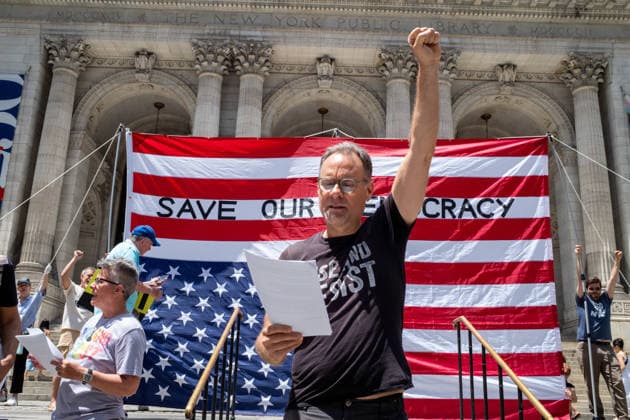 June 14, 2026, New York, New York, USA: Activist group Rise and Resist fly a giant 12x18 upside-down American flag on the steps of the New York Public Library as part of their protest demanding to Ã¢â‚¬oeImpeach, Convict and RemoveÃ¢â‚¬Â PRESIDENT DONALD TRUMP from office. New York USA - ZUMAp288 20260614_znp_p288_001 Copyright: xSyndixPilarx