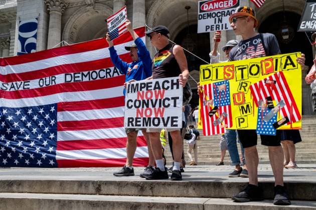 June 14, 2026, New York, New York, USA: Activist group Rise and Resist fly a giant 12x18 upside-down American flag on the steps of the New York Public Library as part of their protest demanding to Ã¢â‚¬oeImpeach, Convict and RemoveÃ¢â‚¬Â PRESIDENT DONALD TRUMP from office. New York USA - ZUMAp288 20260614_znp_p288_004 Copyright: xSyndixPilarx