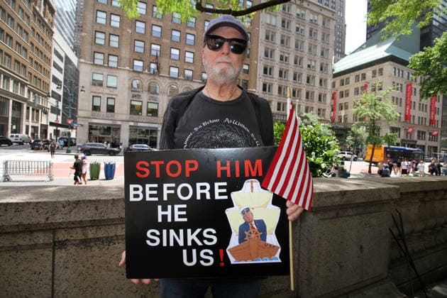 June 14, 2026, Manhattan, New York, USA: New York, New York June 14,.2026... The group Rise and Resist today protested President Trump by flying a 12 x 18 foot Ã¢â‚¬oedistressedÃ¢â‚¬Â American flag in front of a place free of Trump & Republicans, the steps of the New York Public Library. Manhattan USA  - ZUMAct2_ 20260614_faf_ct2_035 Copyright: xBrucexCotlerx