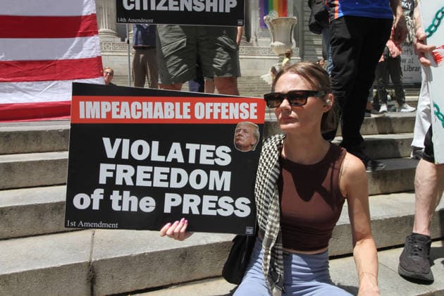 June 14, 2026, Manhattan, New York, USA: New York, New York June 14,.2026... The group Rise and Resist today protested President Trump by flying a 12 x 18 foot Ã¢â‚¬oedistressedÃ¢â‚¬Â American flag in front of a place free of Trump & Republicans, the steps of the New York Public Library. Manhattan USA  - ZUMAct2_ 20260614_faf_ct2_044 Copyright: xBrucexCotlerx