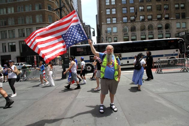 June 14, 2026, Manhattan, New York, USA: New York, New York June 14,.2026... The group Rise and Resist today protested President Trump by flying a 12 x 18 foot Ã¢â‚¬oedistressedÃ¢â‚¬Â American flag in front of a place free of Trump & Republicans, the steps of the New York Public Library. Manhattan USA  - ZUMAct2_ 20260614_faf_ct2_046 Copyright: xBrucexCotlerx