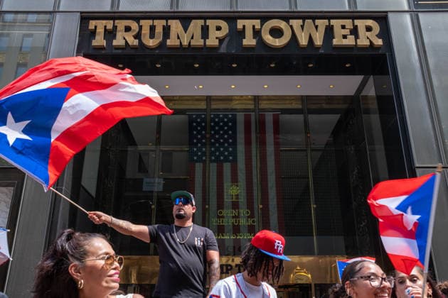 June 14, 2026, New York, New York, USA: A man waves a giant Puerto Rican flag in front of Trump Tower as the 69th Puerto Rican Day Parade makes its way up Fifth avenue. New York USA  - ZUMAp288 20260614_znp_p288_018 Copyright: xSyndixPilarx