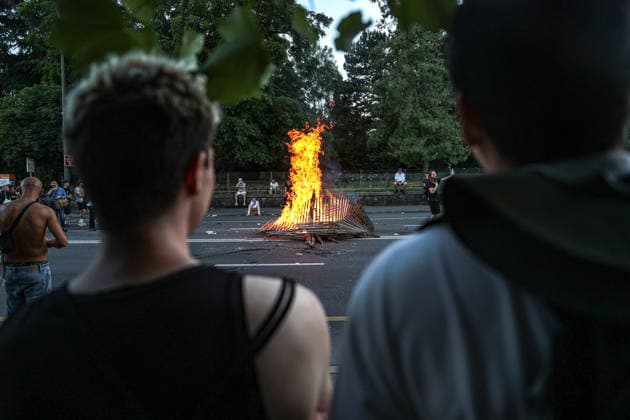 June 14, 2026, Geneva, Switzerland, European Union: A couple watches from behind as a fire burns from debris in the street during demonstrations in Geneva ahead of the G7 summit, which begins tomorrow in Evian-les-Bains. Geneva European Union  - ZUMAo116 20260614_znp_o116_027 Copyright: xBiancaxOterox