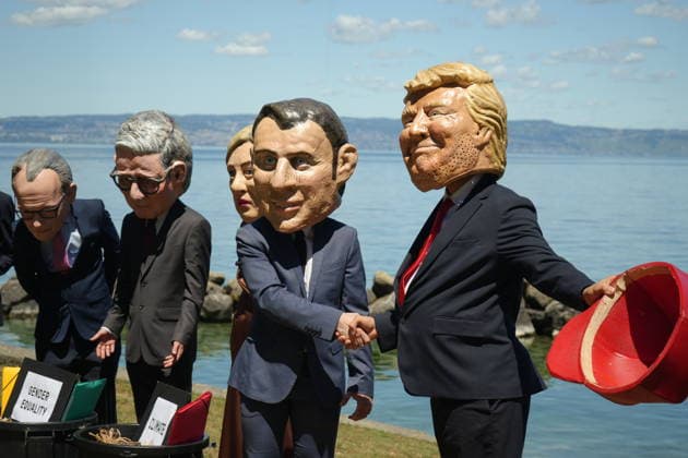 News Bilder des Tages #2 Oxfam protest ahead of G7 Summit in France EVIAN-LES-BAINS, FRANCE - JUNE 14: Activists wearing oversized papier-mache masks depicting world leaders, including U.S. President Donald Trump and French President Emmanuel Macron, take part in an Oxfam demonstration ahead of the G7 Summit in Evian-les-Bains, France, on June 14, 2026. The anti-poverty charity staged the protest to call attention to climate change and gender equality issues ahead of the gathering of G7 leaders. Stringer Anadolu Evian-les-Bains France. Editorial use only. Please get in touch for any other usage.  Copyright: x2026xAnadoluxStringerx