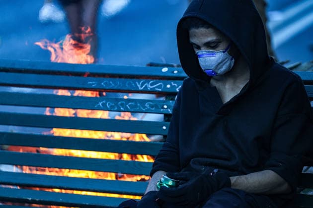 June 14, 2026, Geneva, Switzerland, European Union: Young demonstrator dressed in black and wearing face mask sits on a burning bench during demonstrations in Geneva ahead of the G7 summit, which begins tomorrow in Evian-les-Bains. Geneva European Union  - ZUMAo116 20260614_znp_o116_060 Copyright: xBiancaxOterox