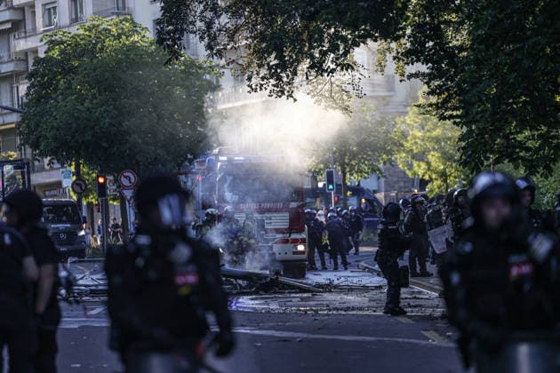 June 14, 2026, Geneva, Switzerland, European Union: Police officers in riot gear stand as a fire truck is seen through lingering tear gas smoke during demonstrations in Geneva ahead of the G7 summit, which begins tomorrow in Evian-les-Bains. Geneva European Union - ZUMAo116 20260614_znp_o116_044 Copyright: xBiancaxOterox
