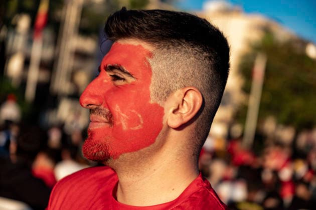 Turkish Fans Gather for the Match A Turkish fan wearing face paint stands among supporters gathered to watch the FIFA World Cup Group D match between Turkey and Australia on a giant screen in the Konak district of Izmir, Turkey, on June 14, 2026. This marks Turkey s first appearance in the FIFA World Cup finals since the 2002 tournament. Turkey finished third at the 2002 FIFA World Cup. Izmir Izmir Turkey Copyright: xMuratxKocabasx