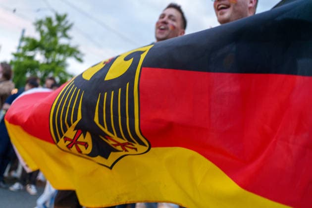 Germany Victory Celebrations Disrupt Traffic in Kassel Germany - Kassel, 14.06.2026 German flag is shown centered as Germany supporters celebrate following Germany s 7-1 victory over Curacao in a FIFA World Cup 2026 Group E match. Large crowds gathered near the Auestadion and the Probonio Arena public viewing site, blocking traffic, climbing onto vehicles and waving German flags during spontaneous post-match celebrations. Police later secured the area. Hesse
