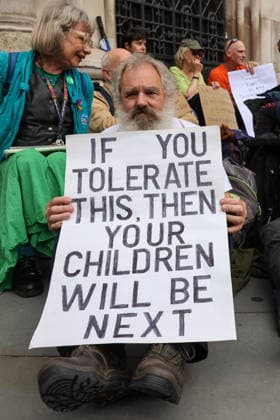 June 15, 2026, London, London, UK: London, UK. A supporter of Palestine Action holds a placard during a protest outside the Royal Courts of Justice in London ahead of the court s judgment on the government s appeal over the proscription of Palestine Action under terrorism laws. London UK  - ZUMAl94_ 20260615_zaf_l94_040 Copyright: xDinendraxHariax